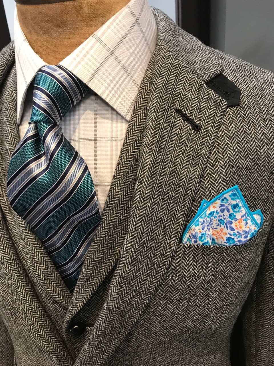 Herringbone tweed jacket with a silk tie and pocket square