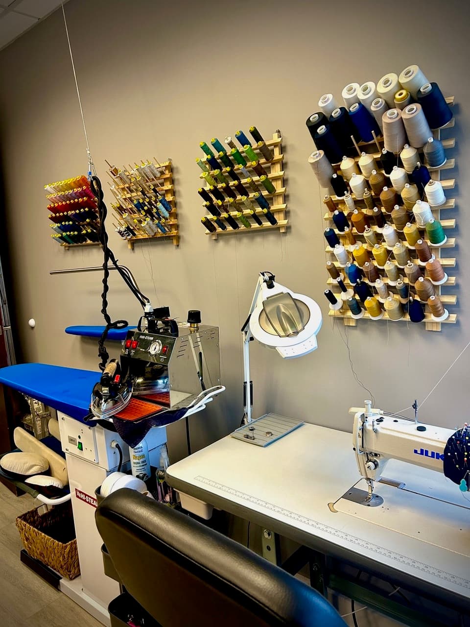 The tailor shop — an industrial press beside racks of thread