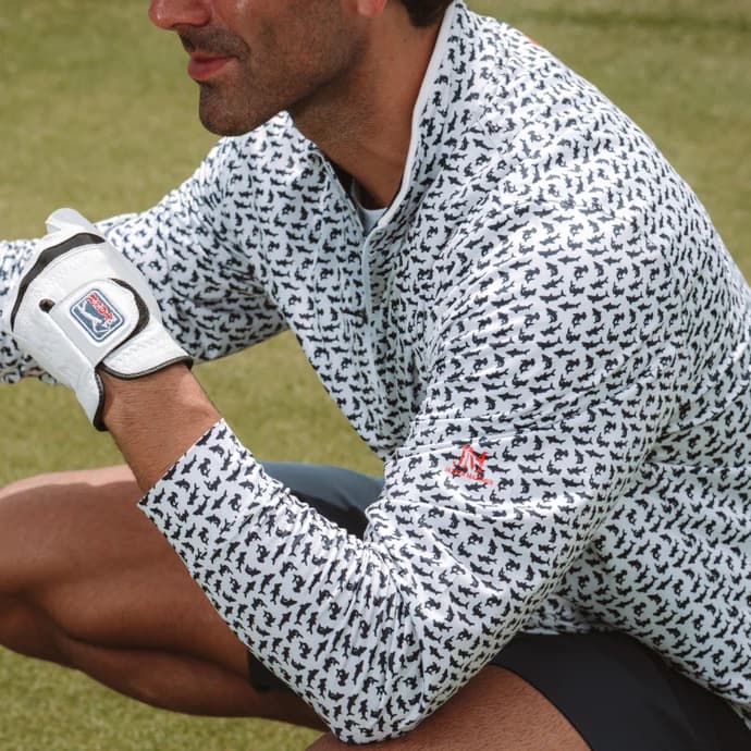 Golfer on the green in a shark-print performance quarter-zip