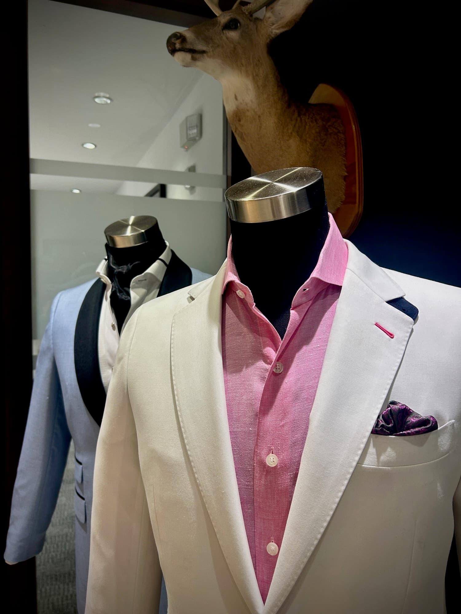 Custom suits on display forms in the studio